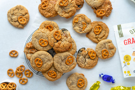 Grain-Free Pretzel Cookies and grain-free pretzels on plate and counter. Otto's Naturals Grain-Free Ultimate Cookie Mix at the side