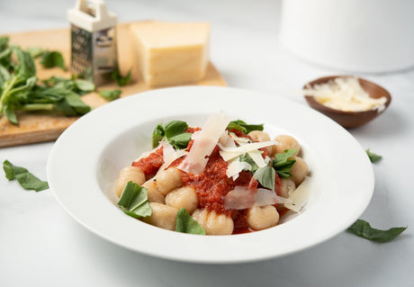 Large pan of cauliflower gnocchi made with cassava flour, coated in cream sauce
