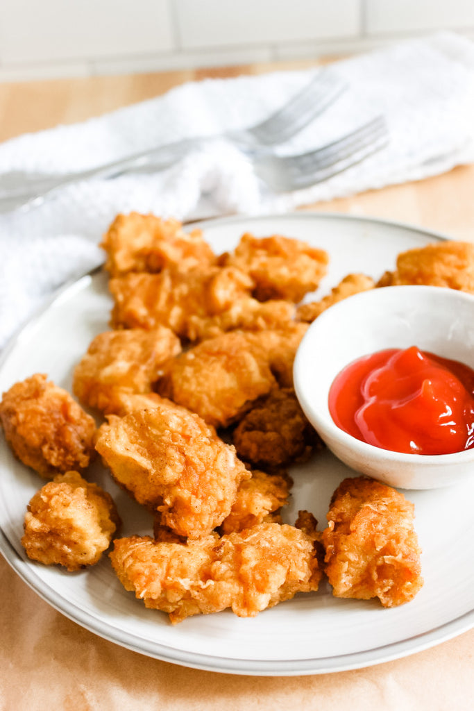 Grain-free chick-fil-a copycat nuggets on plate with ketchup