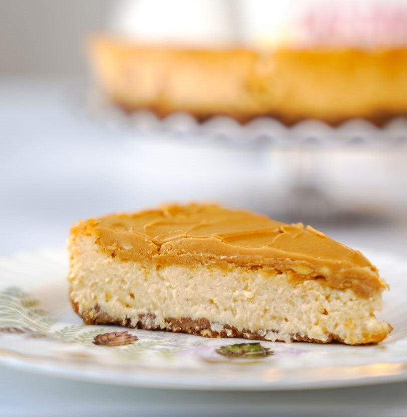 grain-free vegan slice of pumpkin spiced cheesecake with glaze
